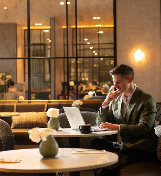 Man with a laptop at Dorsett Melbourne Club Lounge