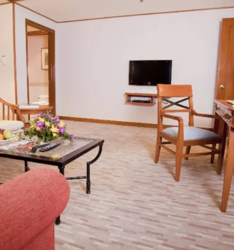 TV, sofa and work desk in the Dorsett Grand Labuan Premier Suite.