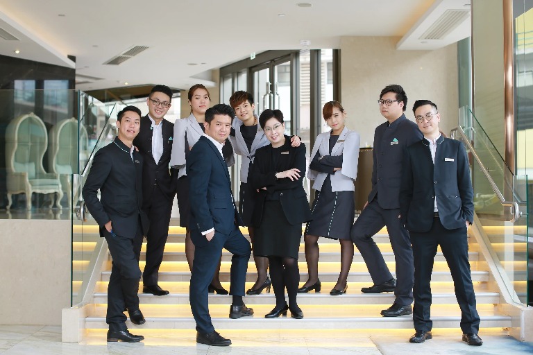 Dorsett Staff on a stairway posing to the camera.