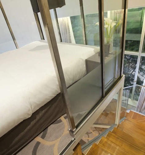 Bed beside the stairway in the Dorsett Loft Room at Dorsett Singapore.
