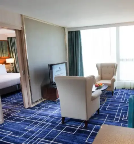 Settee and TV in the Premier Suite living room, Dorsett Tsuen Wan.