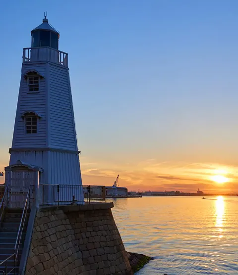 3D render of Old Sakai Lighthouse by the waterfront during sunset