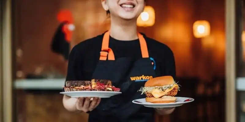 Waitress holding two sandwiches